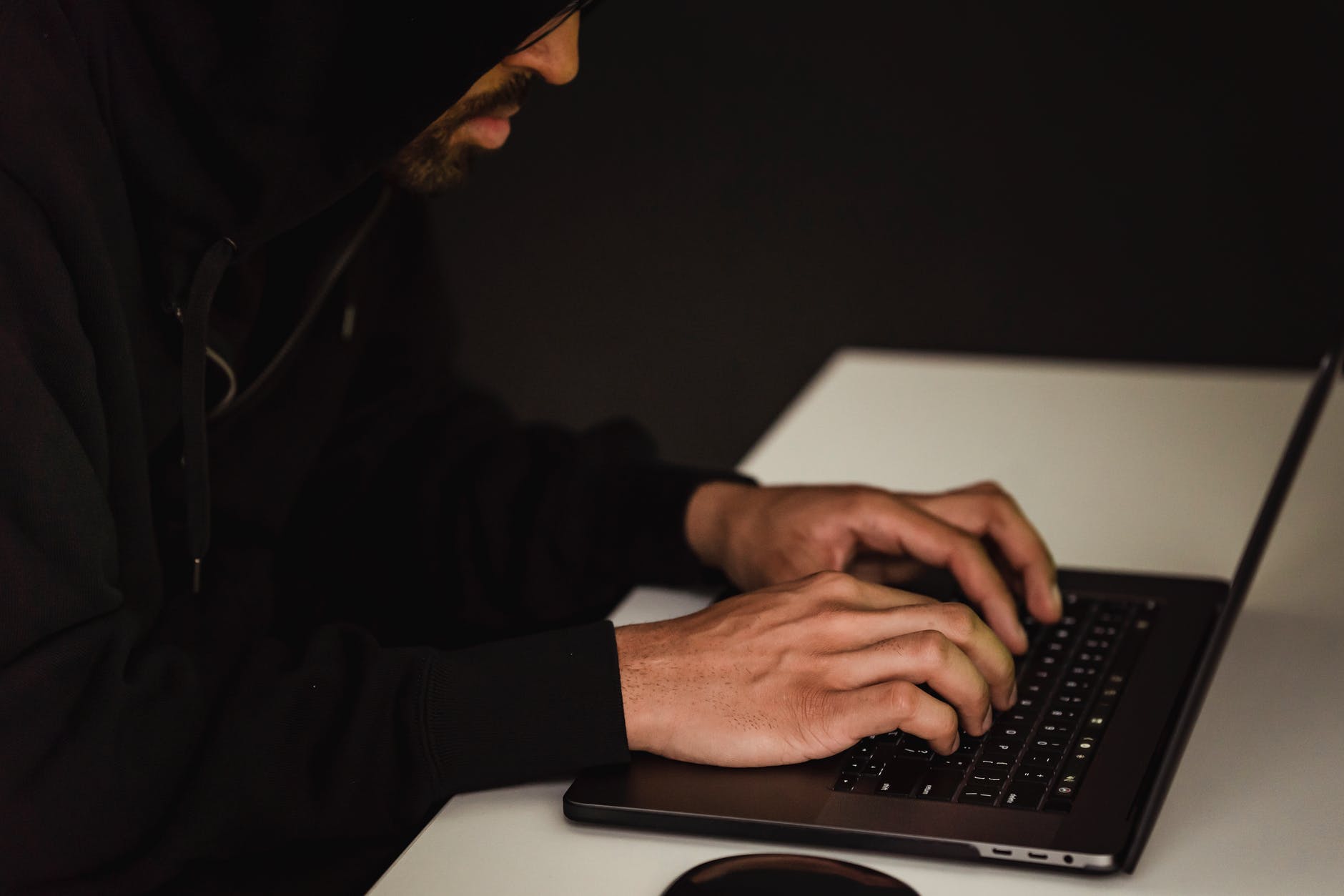 crop focused programmer hacking database on laptop